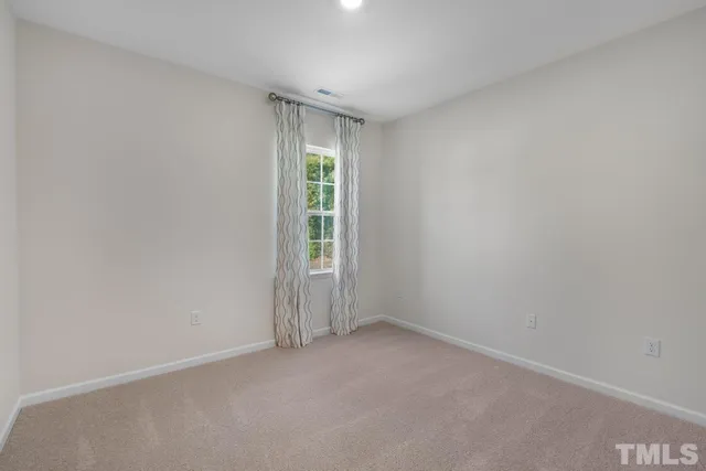 an empty room with a empty space and window