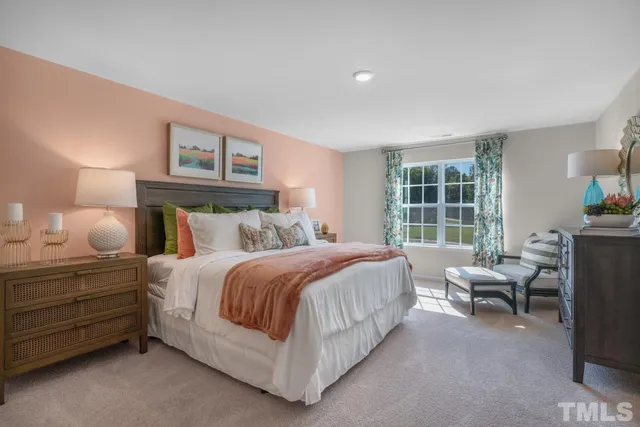 a bedroom with a bed chair and a window