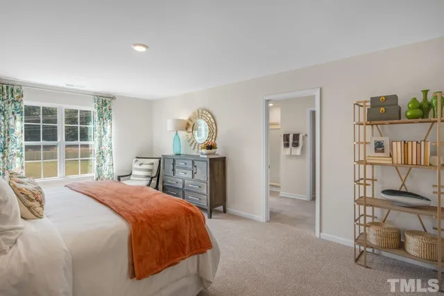 a spacious bedroom with a bed and a window