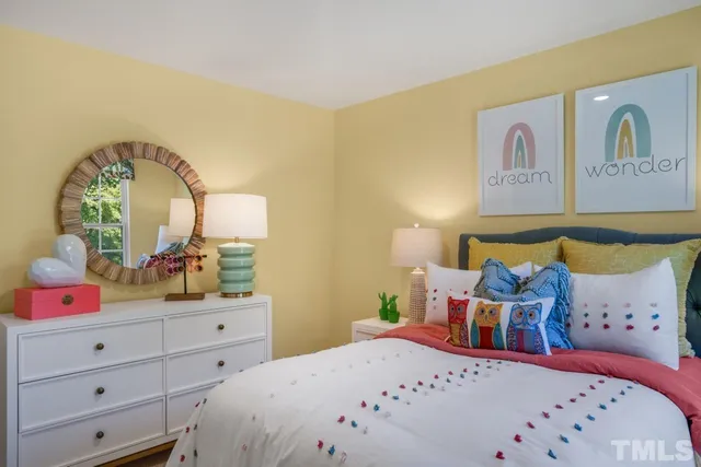 a bedroom with a bed a couch and dresser