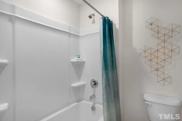 a bathroom with a toilet and a bathtub