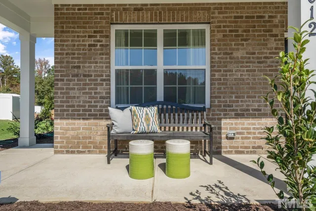 a view of a house with outdoor seating space