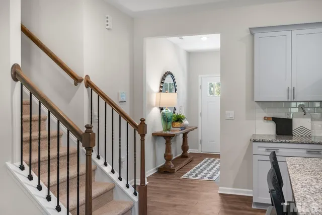 a view of entryway and hall with wooden floor