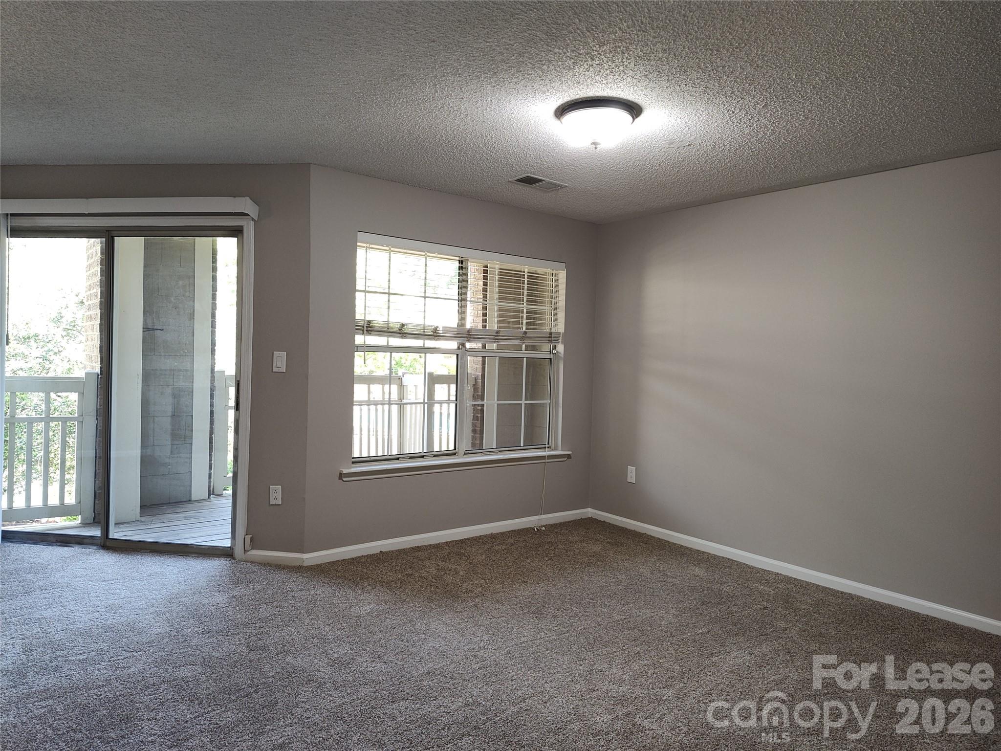 5001 Sharon Road, Unit K Charlotte, NC 28210 - Photo 14 of 24 an empty room with a window