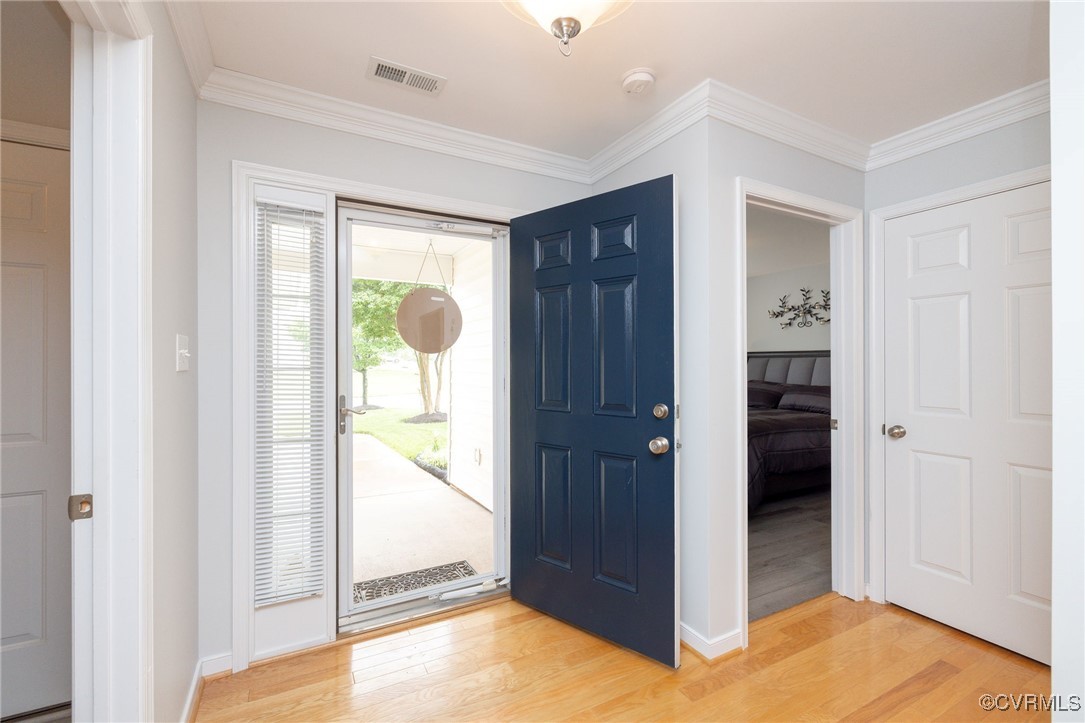 2165 Kennington Park Road, Unit 6 Aylett, VA 23009 - Photo 4 of 36 Foyer with storm door, wood flooring and crown mol