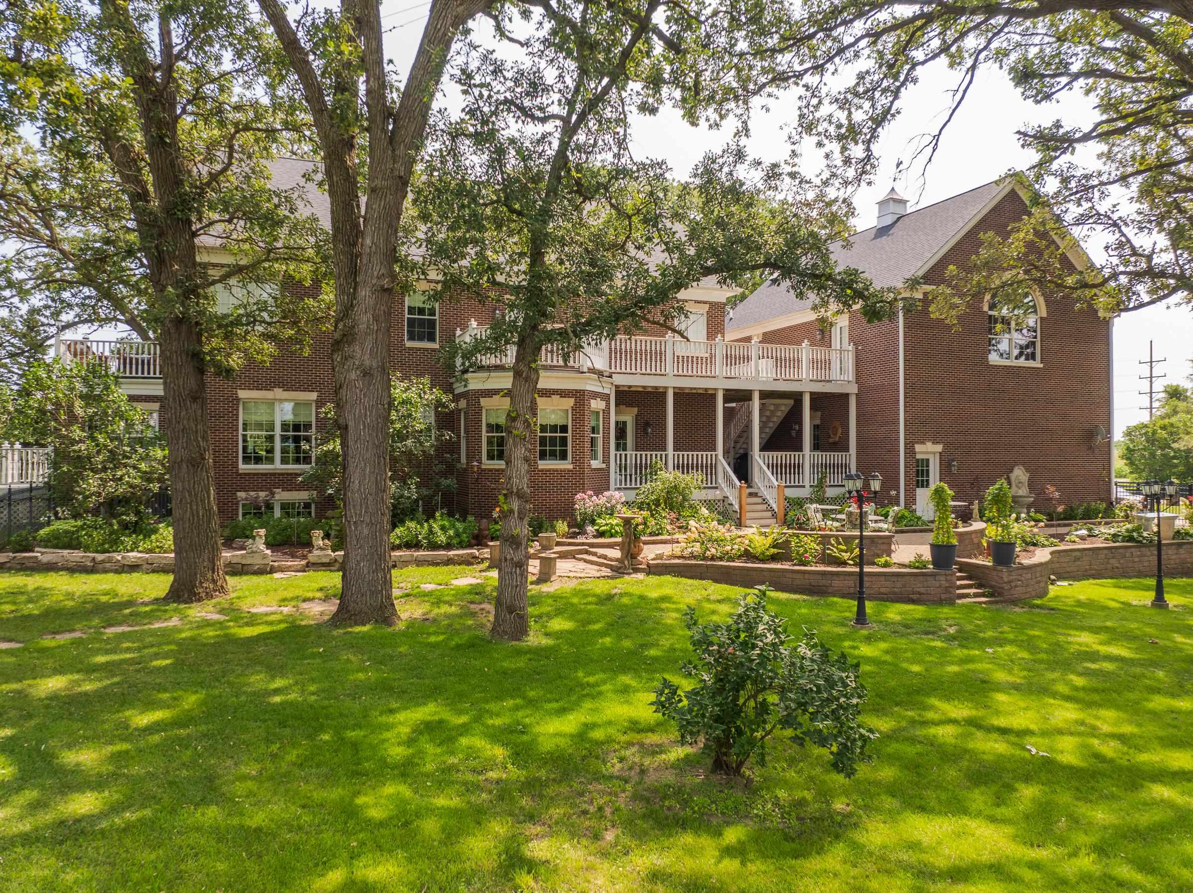 6715 Meyer Road Marengo, IL 60152 - Photo 3 of 72 a front view of a house with swimming pool and garden