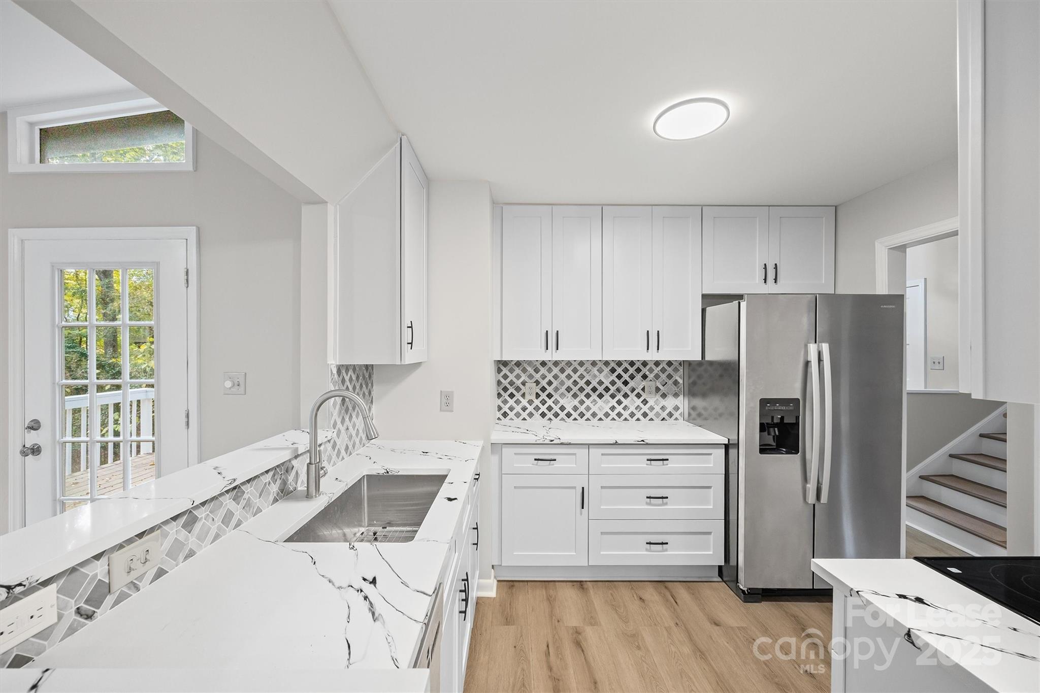 6012 Lanai Lane Fort Mill, SC 29708 - Photo 12 of 32 a kitchen with a stove a refrigerator and a sink with wooden floor