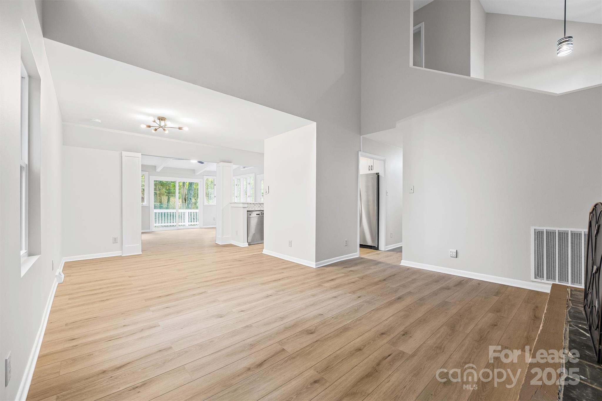 6012 Lanai Lane Fort Mill, SC 29708 - Photo 8 of 32 a view of an empty room with wooden floor and a window