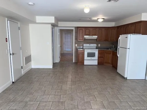 a kitchen with a refrigerator and a stove