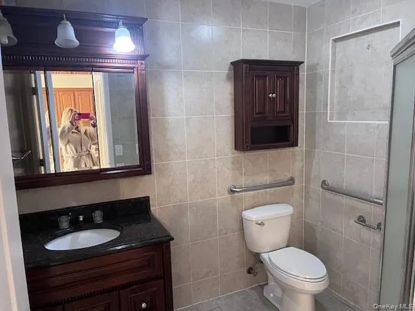 a bathroom with a toilet a sink and mirror