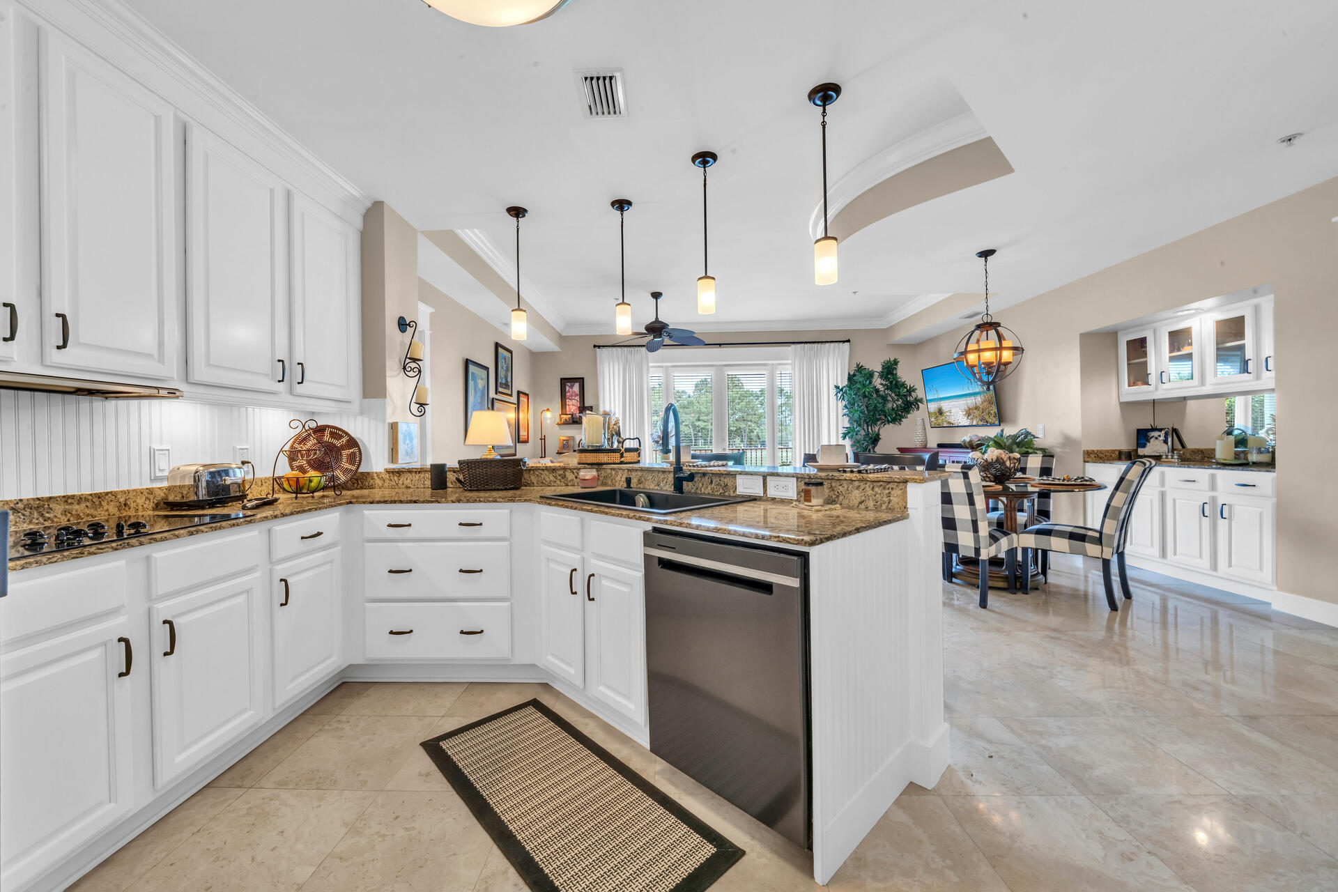 5357 Pine Ridge Lane, Unit 5357 Miramar Beach, FL 32550 - Photo 19 of 53 a kitchen with white cabinets and chairs