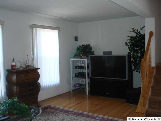 43 Saxton Road Farmingdale, NJ 07727 - Photo 3 of 3 a living room with furniture and a potted plant