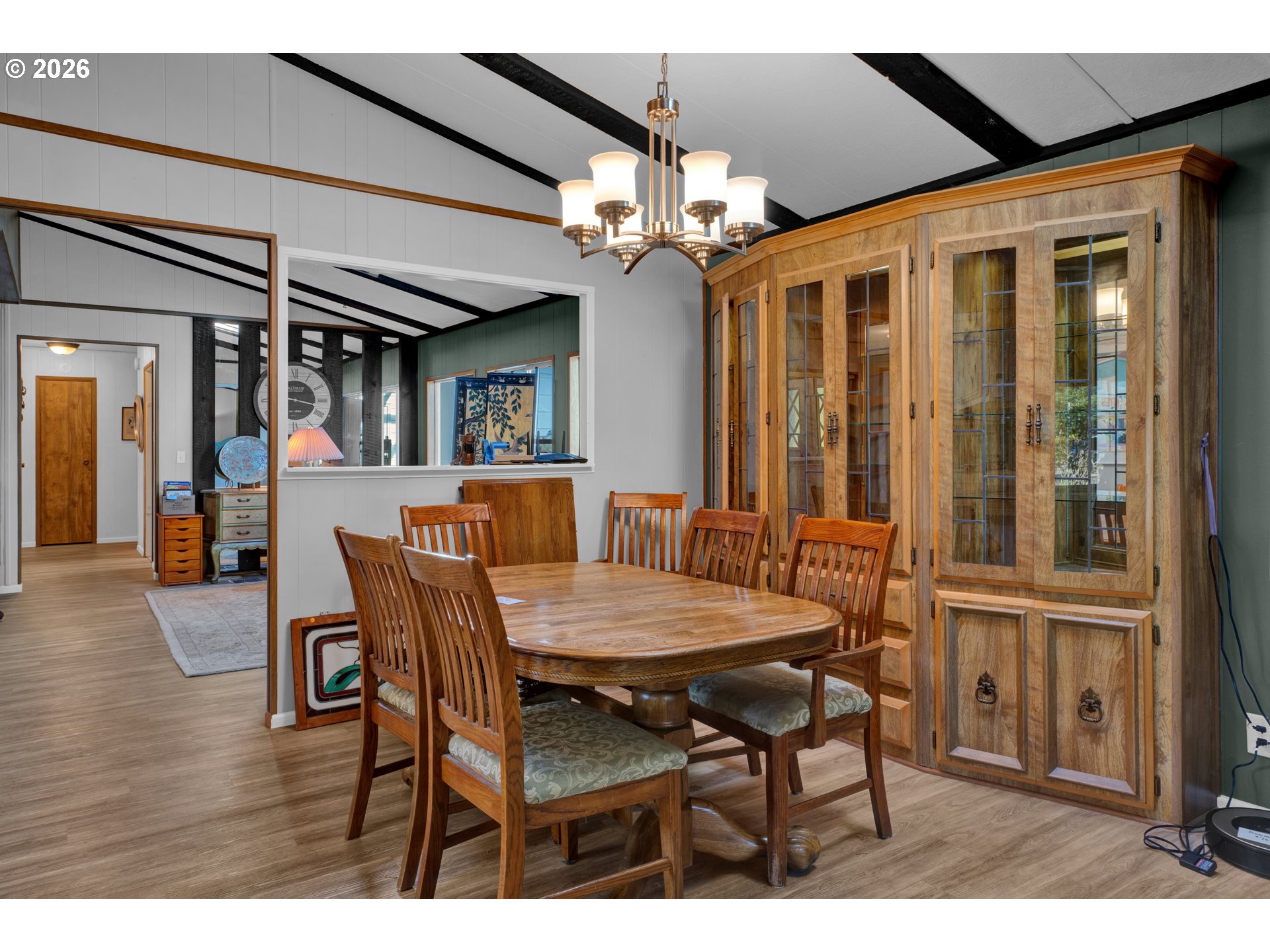 1601 Rhododendron Drive, Unit 534 Florence, OR 97439 - Photo 11 of 48 a dining room with furniture a chandelier and wooden floor
