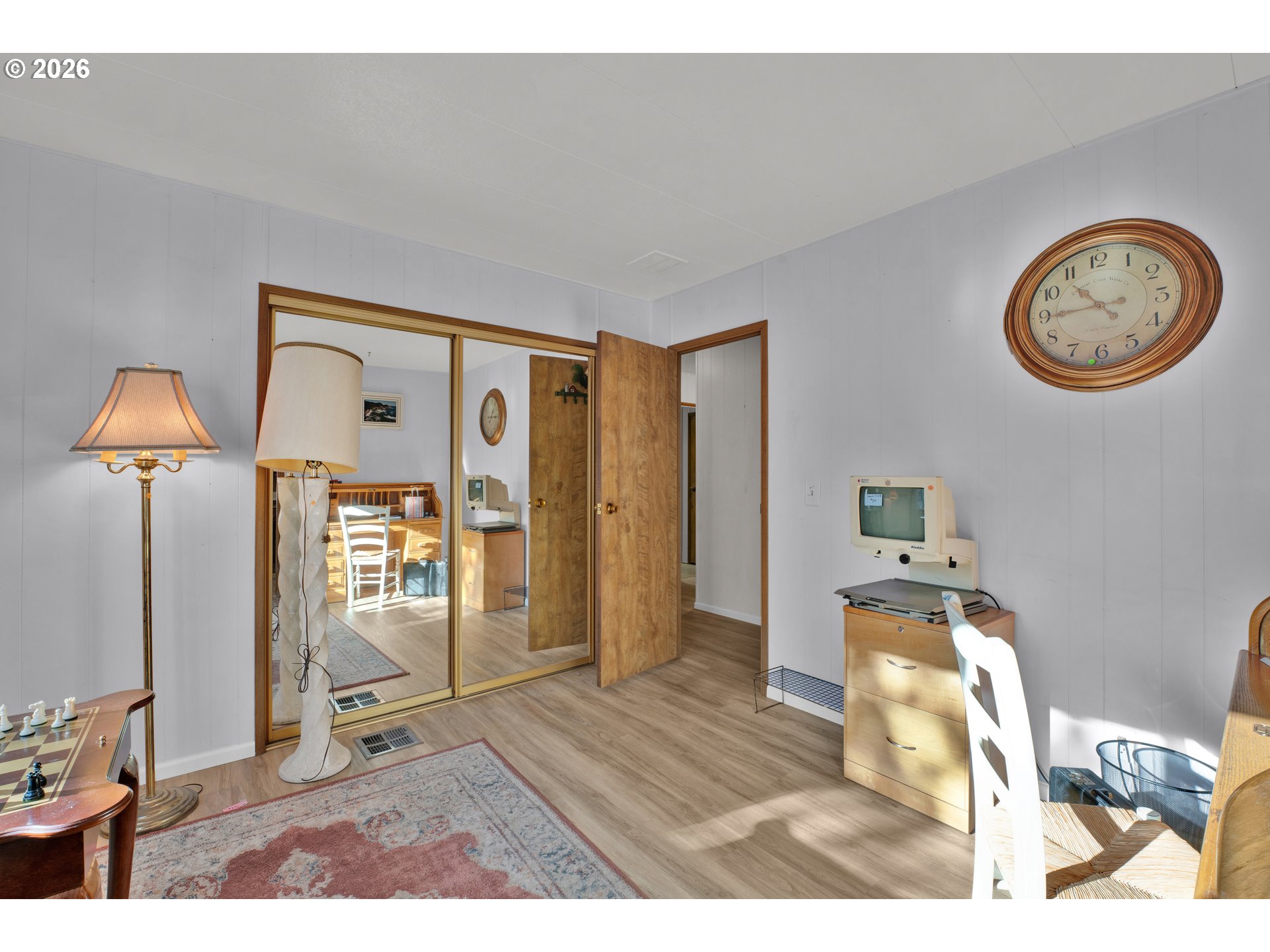 1601 Rhododendron Drive, Unit 534 Florence, OR 97439 - Photo 27 of 48 a view of a livingroom with furniture wooden floor and a mirror