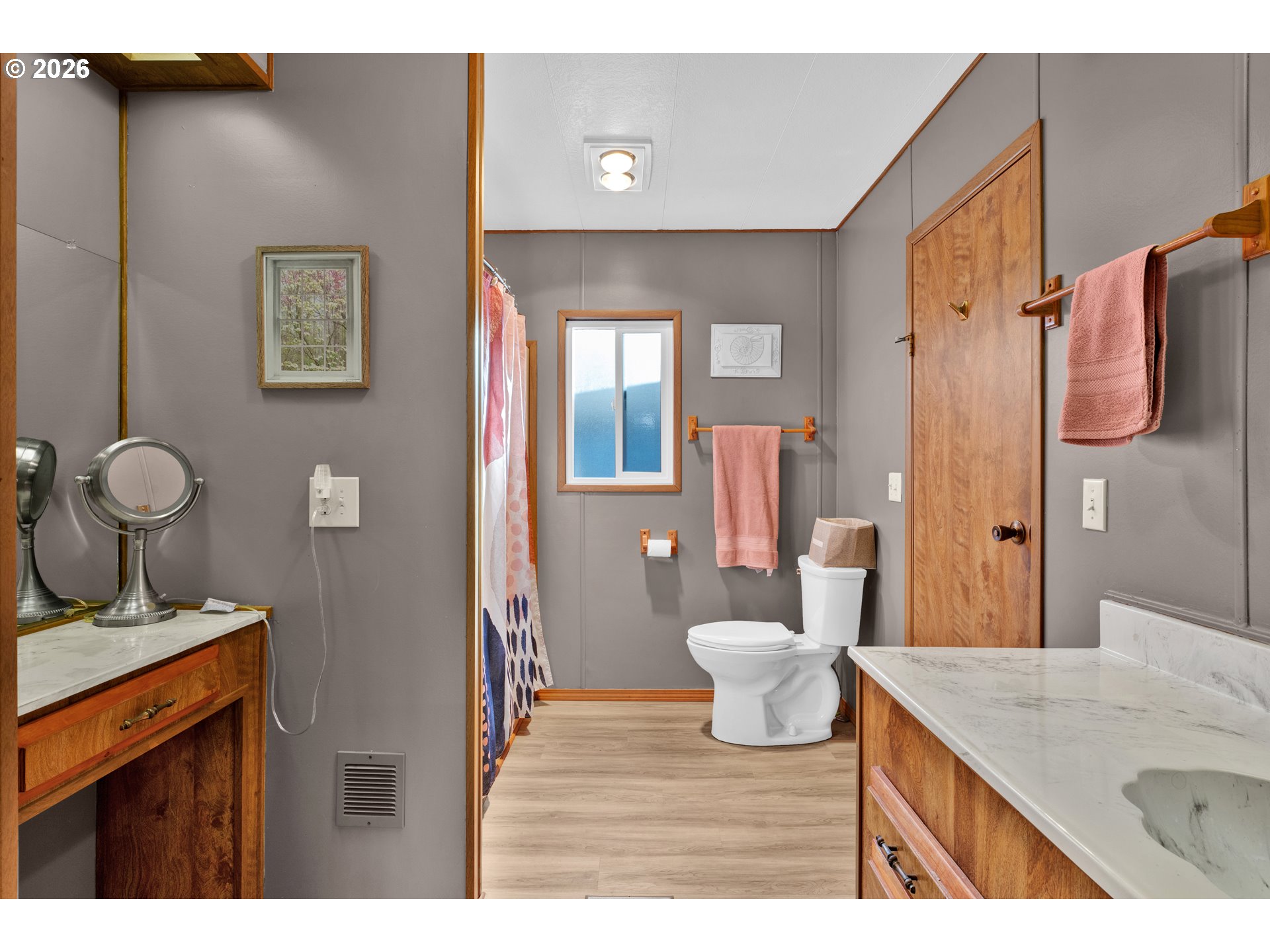 1601 Rhododendron Drive, Unit 534 Florence, OR 97439 - Photo 29 of 48 a bathroom with a granite countertop sink a toilet and a mirror