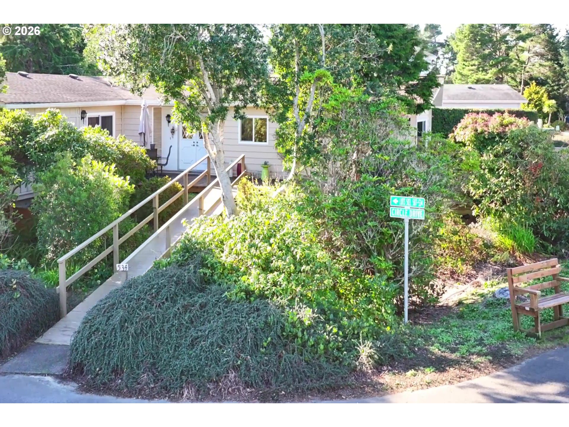 1601 Rhododendron Drive, Unit 534 Florence, OR 97439 - Photo 41 of 48 a view of a garden with a building in the background