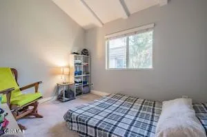a bedroom with a bed a table and chair