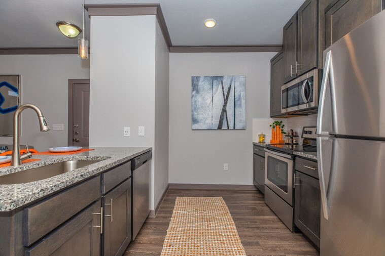 9393 Fm 1960 Bypass Road West, Unit 2112 Humble, TX 77338 - Photo 6 of 28 a kitchen with stainless steel appliances granite countertop a refrigerator and a sink