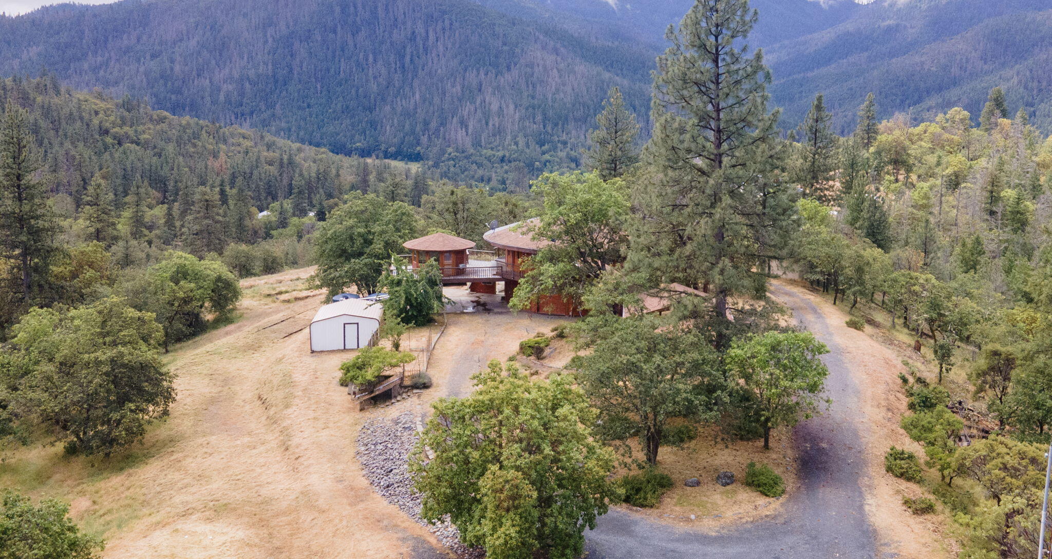 9595 Sterling Creek Road Jacksonville, OR 97530 - Photo 3 of 76 a view of a park with large trees