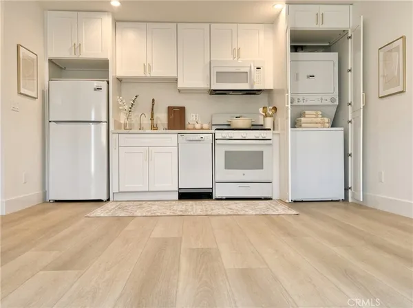 a kitchen with stainless steel appliances a refrigerator sink and cabinets