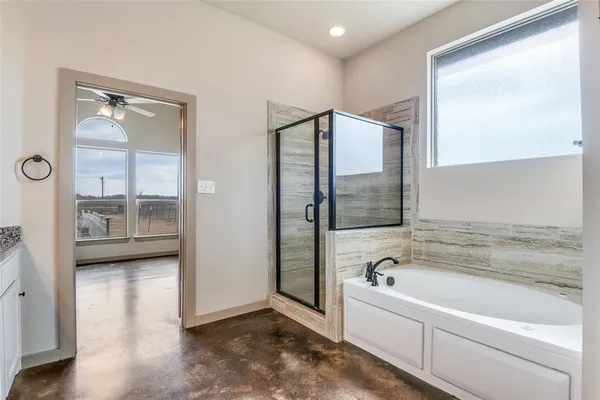 a spacious bathroom with a tub and shower