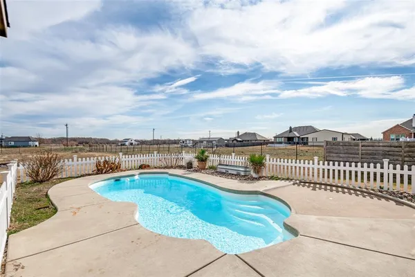 a view of a swimming pool with a lounge chair