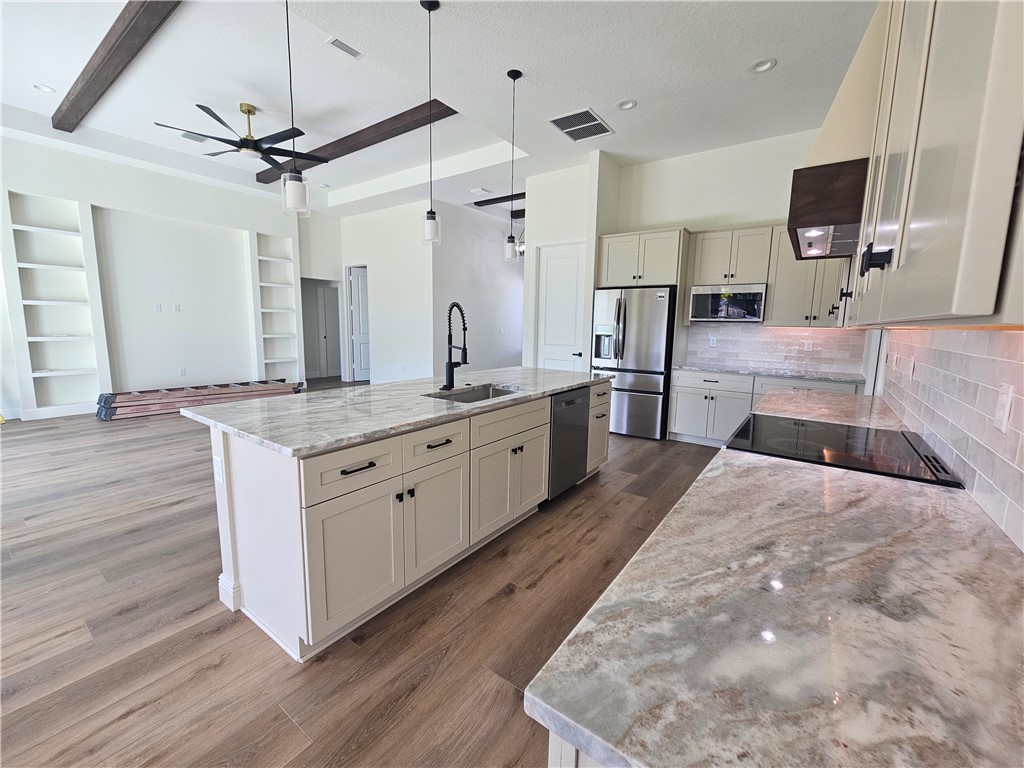 961 George Street Sebastian, FL 32958 - Photo 10 of 18 a large white kitchen with a stove a sink and a refrigerator