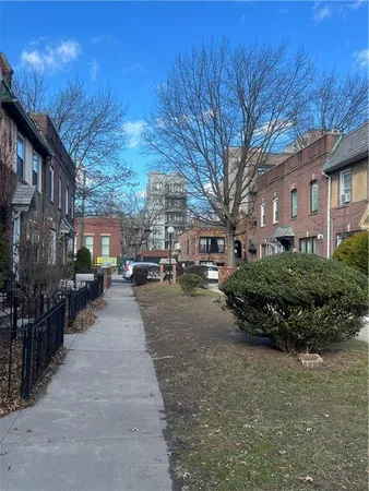 a view of a street with brick building in the background