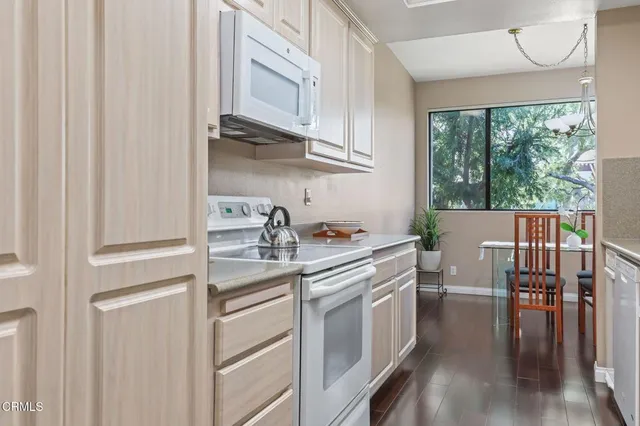 a kitchen with a sink cabinets and wooden floor