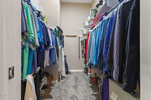 a view of walk in closet with clothes