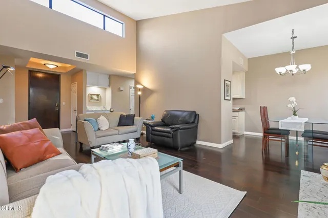 a living room with furniture and a chandelier