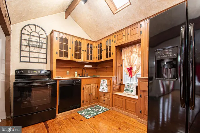 a kitchen with stainless steel appliances granite countertop a stove and a refrigerator