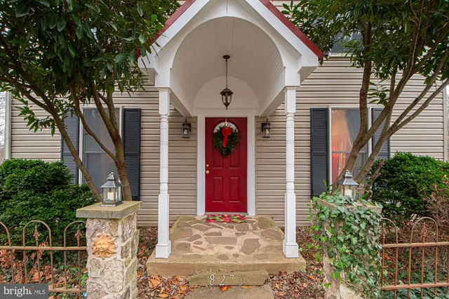 a front view of a house with plants