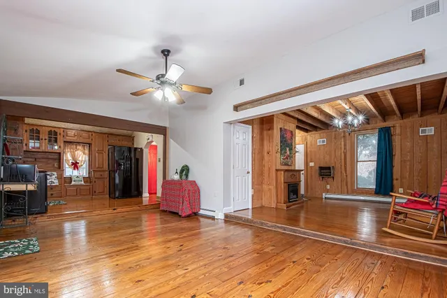 a view of living room with furniture and wooden floor