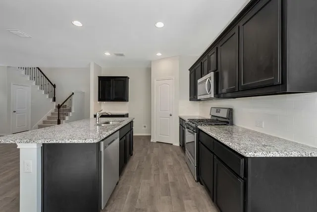 a bath room with a sink and dishwasher