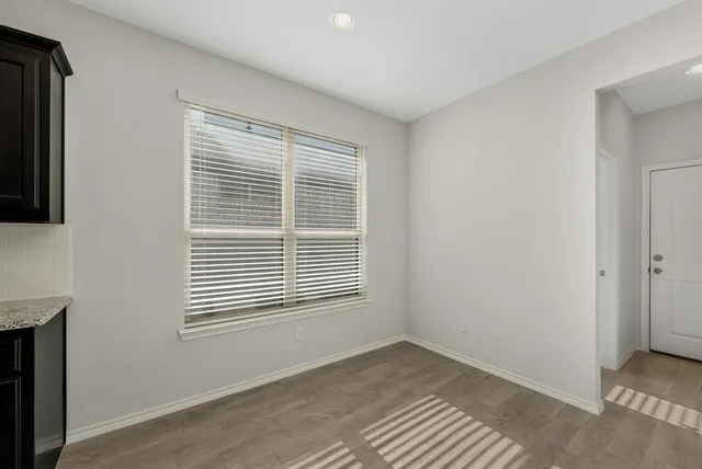 an empty room with a empty space and windows