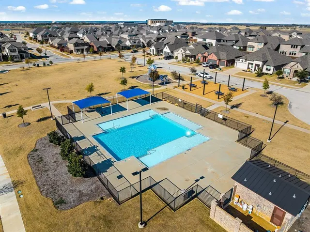 an aerial view of a residential building and ocean view