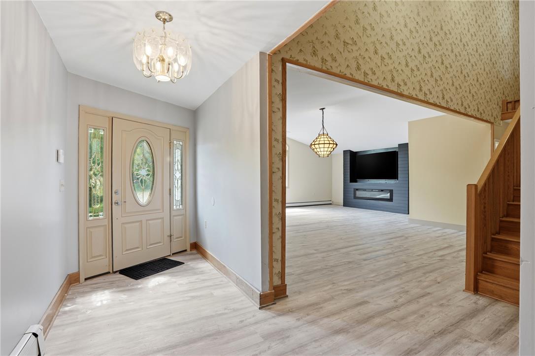 6271 Batman Road Zionsville, PA 18092 - Photo 28 of 100 A welcoming entryway with a decorative front door and bright lighting leads to spacious living areas.
