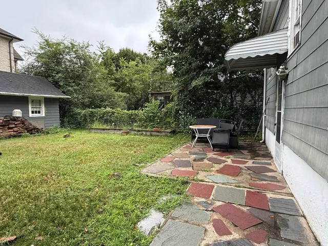 a view of backyard with seating space