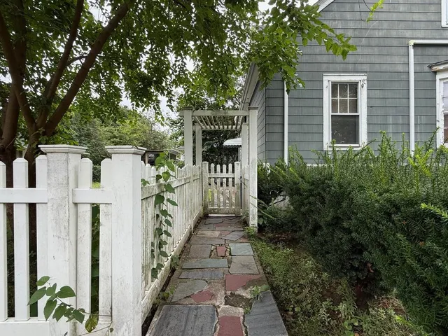 a view of a pathway of house with yard