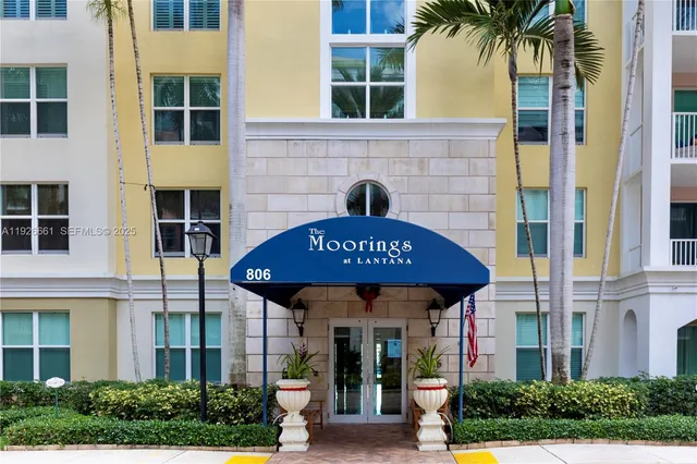 a front view of a building with garden and entryway