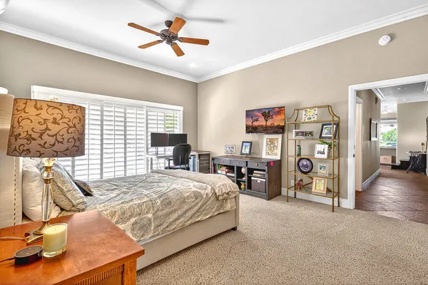 a bedroom with a bed and glass walk in closet