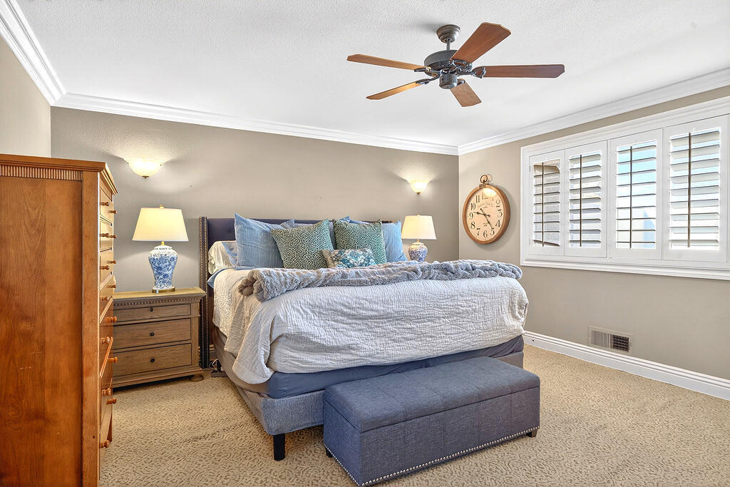 10 Colonial Drive Rancho Mirage, CA 92270 - Photo 19 of 25 a bed room with a bed and a ceiling fan