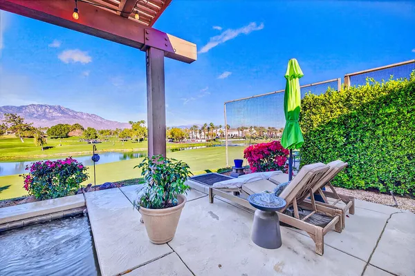 a view of a patio with a table and chairs and potted plants