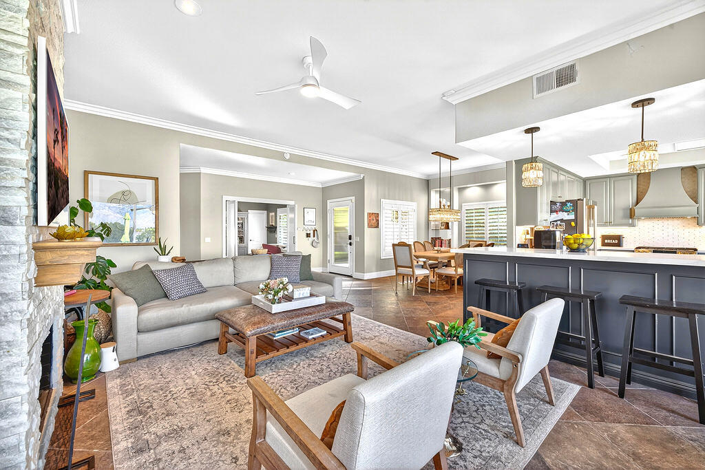 10 Colonial Drive Rancho Mirage, CA 92270 - Photo 21 of 25 a living room with furniture kitchen view and a chandelier