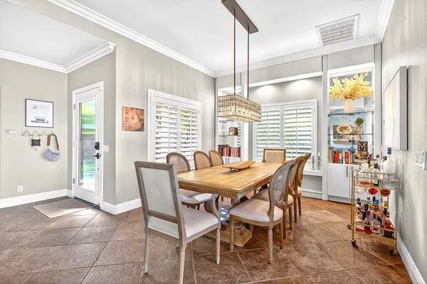 a view of a dining room with furniture and chandelier