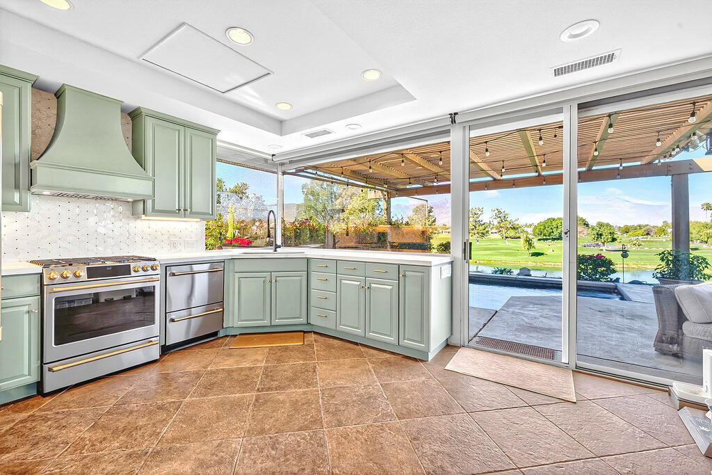 10 Colonial Drive Rancho Mirage, CA 92270 - Photo 10 of 25 a kitchen with a stove a sink and a refrigerator