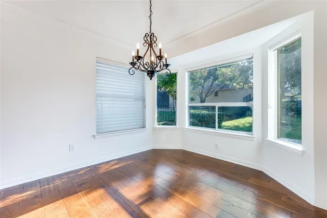 a view of a room with a large window and chandelier