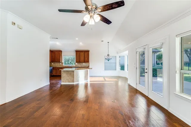 a view of kitchen with refrigerator stove and wooden floor