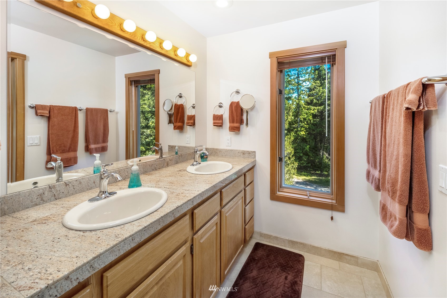 338 Sunrise Ridge Road San Juan Island, WA 98250 - Photo 16 of 39 a bathroom with a granite countertop sink and a mirror